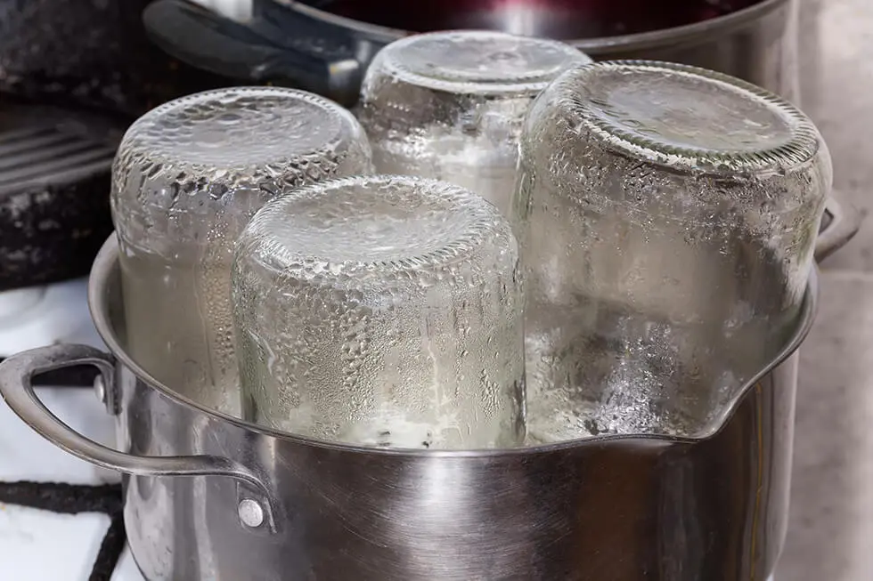 Disinfection of glass jars by boiling in a steel pot