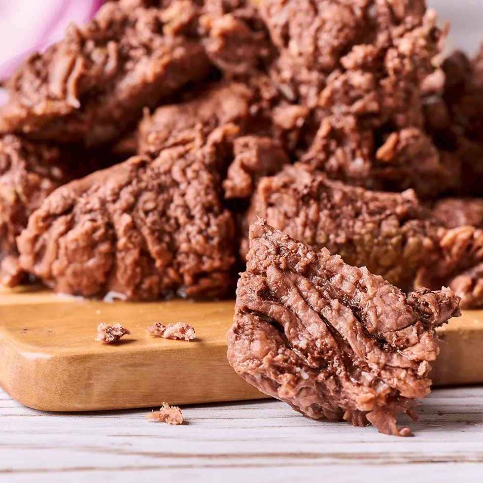 Cooked meat on a wood slicing table