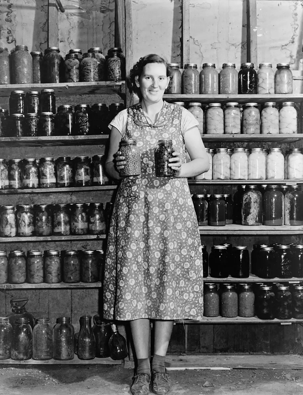 Housewife proudly displays her home grown and canned food